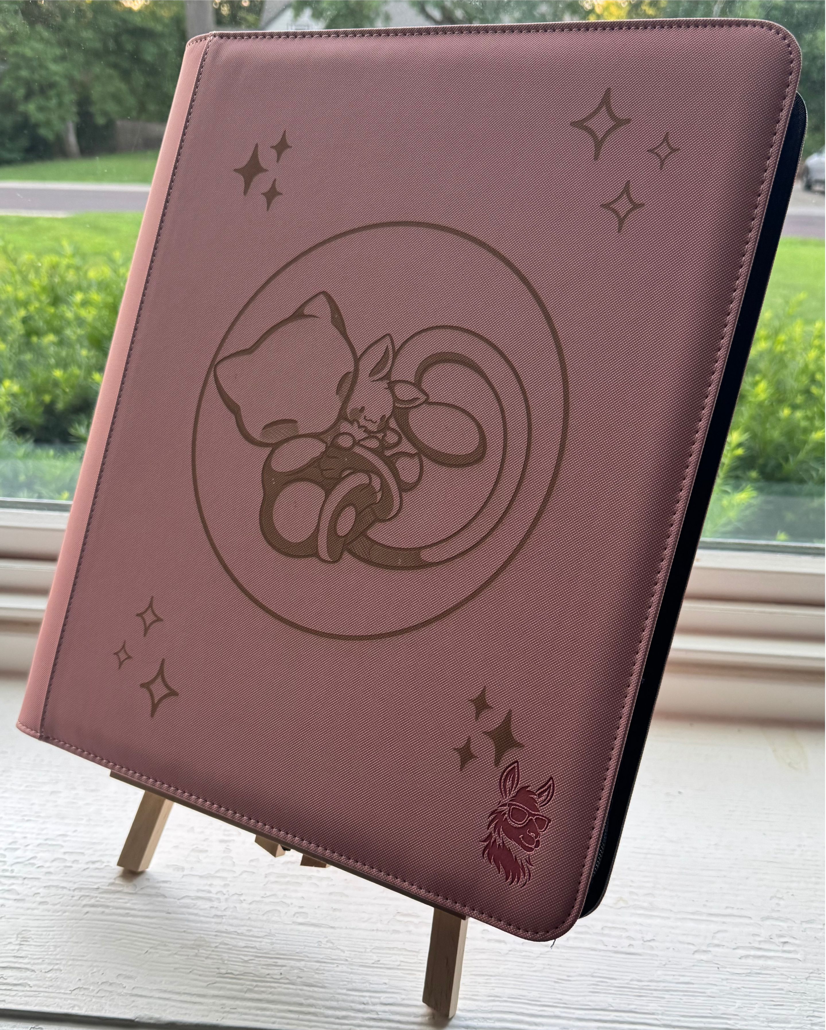 Pink TCG Binder with Mew hugging an Eevee in a bubble mew design.